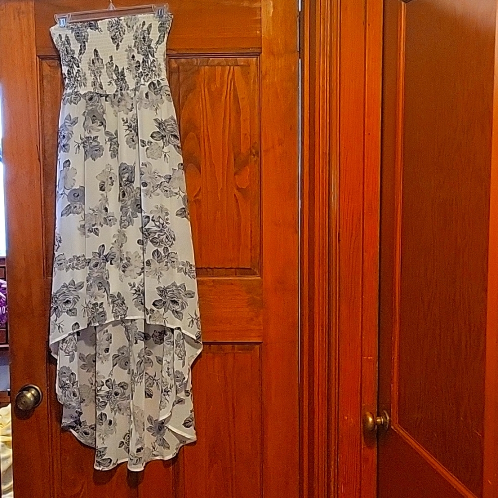 A Guess high low strapless dress that's white with grey and black roses